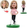 Gelukkig vrouwelijke Golf Bobblehead in roze shirt